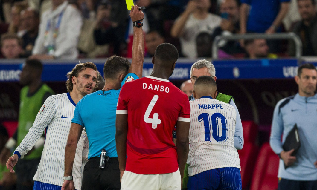 Düsseldorf Arena Referee Jesus Gil Manzano (L) shows a yellow card for Kylian MbappĂ of France (R) during the UEFA EURO,