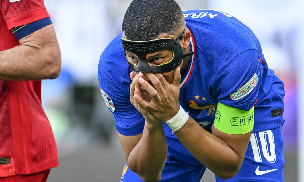 240625 EURO2024 FRANCE VS POLAND Kylian Mbappe (10) of France in pain and checks his nose under his mask during a soccer