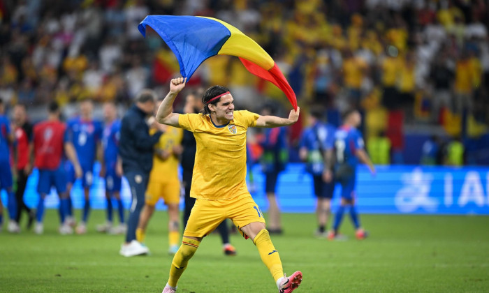 26 June 2024, Hesse, Frankfurt/M.: Soccer, UEFA Euro 2024, European Championship, Slovakia - Romania, Preliminary round, Group E, Matchday 3, Frankfurt Arena, Romania's Ianis Hagi celebrates the 1-1 draw with a flag on the pitch after the final whistle. P