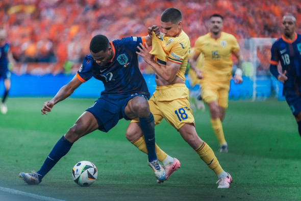 EURO 2024 - Round of 16: Romania vs. The Netherlands Denzel Dumfries and Razvan Marin fight for the ball during the EURO