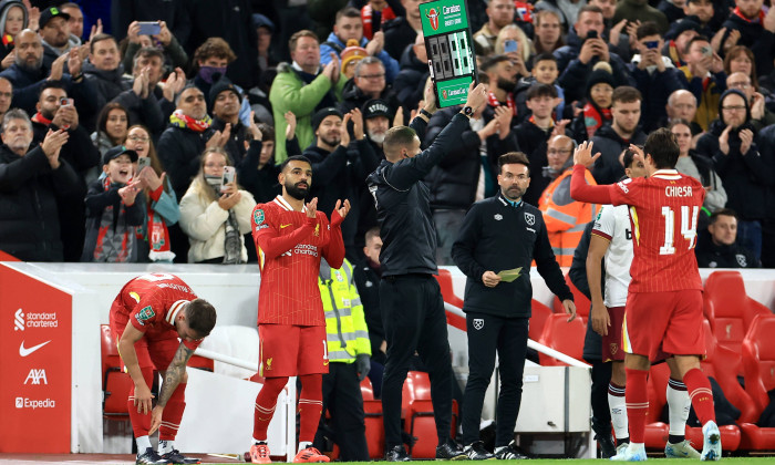 Liverpool, England, 25th September 2024. Liverpool s Federico Chiesa is substituted off for teammate Mohamed Salah durin