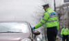 Bucharest, Romania - March 25, 2020: Romanian road police officer pulls over a car to check for the drivers identity papers.