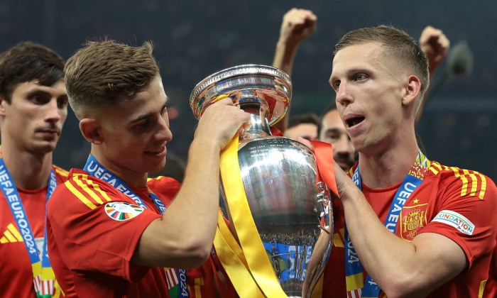 Berlin, Germany, 14th July 2024. Fermin Lopez and Dani Olmo of Spain pose with the Henri Delaunay Cup following the 2-1