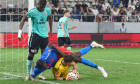 Bucharest, Romania. 1st Sep, 2024: Joyskim Dawa (top) of FCSB falls over UTA goalkeeper Robert Popa during the football match between FCSB and UTA Arad in the 8th round of Superliga, the first league of the Romanian 2024-2025 football championship, at the