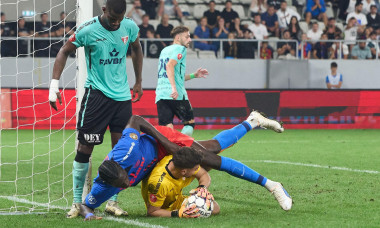 Bucharest, Romania. 1st Sep, 2024: Joyskim Dawa (top) of FCSB falls over UTA goalkeeper Robert Popa during the football match between FCSB and UTA Arad in the 8th round of Superliga, the first league of the Romanian 2024-2025 football championship, at the