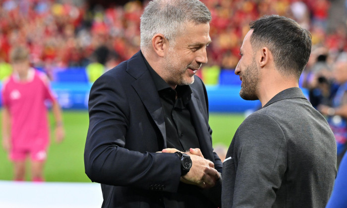 Cologne, Germany. 22nd June, 2024. Coach Edward Iordanescu of Romania and Coach Domenico Tedesco of Belgium greet each other during a soccer game between the national teams of Belgium, called the Red Devils and Romania on the second matchday in Group E in