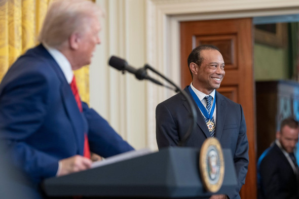 Washington, United States. 20th Feb, 2025. U.S President Donald Trump, left, welcomes golf legend Tiger Woods for Black History Month at the East Room of the White House, February 20, 2025 in Washington, DC. Credit: Daniel Torok/White House Photo/Alamy Li