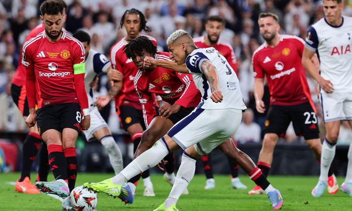 Richarlison de Andrade of Tottenham Hotspur, challenged by Bruno Fernandes and Patrich Dorgu of Manchester United, in action during the 2024/2025 Europa League Final football match between Tottenham Hotspur and Manchester United at San Mames stadium in Bi