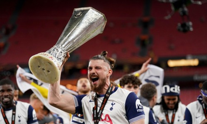 Tottenham Hotspur's Radu Dragusin celebrates with the trophy following the UEFA Europa League final at the Estadio de San Mames in Bilbao, Spain. Picture date: Wednesday May 21, 2025.