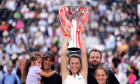 Tatjana Maria celebrates with the trophy alongside her family after defeating Amanda Anisimova during the women’s final on day seven of the HSBC Championships at The Queen's Club, London. Picture date: Sunday June 15, 2025.