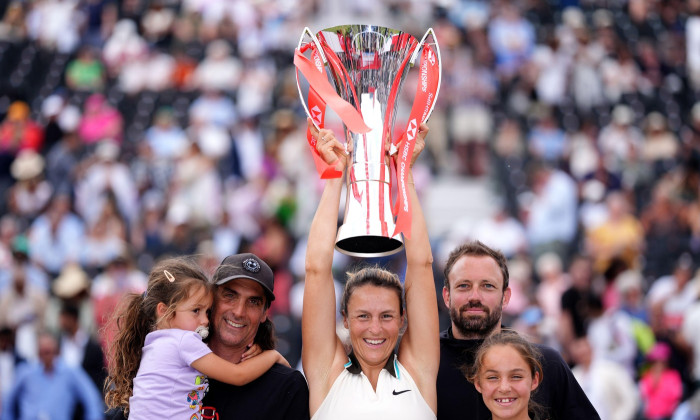 Tatjana Maria celebrates with the trophy alongside her family after defeating Amanda Anisimova during the women’s final on day seven of the HSBC Championships at The Queen's Club, London. Picture date: Sunday June 15, 2025.