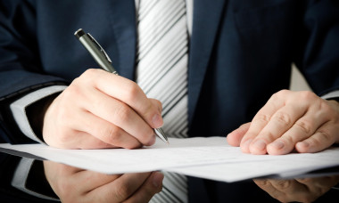 Businessman signs a contract. man contract signing hand writing pen letter paper concept