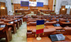 Bucharest, Romania - November 14, 2022: Romanian flag and empty seats in the Romanian Chamber of Deputies inside the Palace of Parliament.