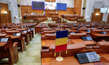 Bucharest, Romania - November 14, 2022: Romanian flag and empty seats in the Romanian Chamber of Deputies inside the Palace of Parliament.