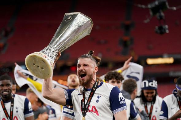 Tottenham Hotspur's Radu Dragusin celebrates with the trophy following the UEFA Europa League final at the Estadio de San Mames in Bilbao, Spain. Picture date: Wednesday May 21, 2025.