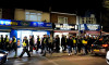Police escort fans to the stadium ahead of the Sky Bet Championship match at Kenilworth Road, Luton. Picture date: Tuesday February 28, 2023.