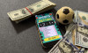 Winning bet on sporting event, money in sport and sports betting conceptual idea with football, soccer ball and cash