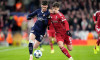 PSV Eindhoven's Dennis Man (left) and Liverpool's Milos Kerkez battle for the ball during the UEFA Champions League, league phase match at Anfield, Liverpool. Picture date: Wednesday November 26, 2025.