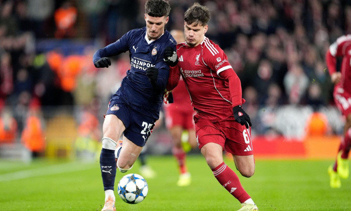 PSV Eindhoven's Dennis Man (left) and Liverpool's Milos Kerkez battle for the ball during the UEFA Champions League, league phase match at Anfield, Liverpool. Picture date: Wednesday November 26, 2025.