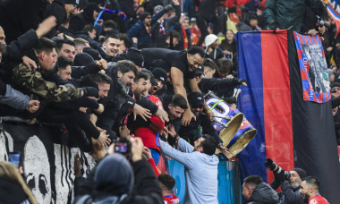 Coach Elias Charalambous celebrates with fans winning the game