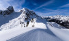 Snowdrift creating artful structures around Giau pass in winter, snow-covered summits of Torre Dusso, Mt. Cernera and Ma