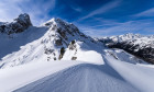 Snowdrift creating artful structures around Giau pass in winter, snow-covered summits of Torre Dusso, Mt. Cernera and Ma