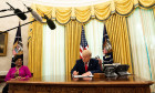 United States President Donald J. Trump signs the document granting Alice Marie Johnson, criminal justice reform advocate, a full pardon in the Oval Office of the White House in Washington, DC. Ms. Johnson looks on from left.Credit: Anna Moneymaker / Pool