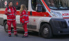 Croce Rossa Italiana (Italian Red Cross) first aid workers standing by their ambulance during an organized event in Catania, Sicily.