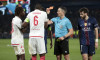 Mamadou Coulibaly of Monaco (left) receives a red card from referee Istvan Kovacs of Romania during the UEFA Champions League Knockout Play-offs Second leg football match between Paris Saint-Germain (PSG) and AS Monaco (ASM) on February 25, 2026 at Parc d