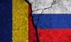 Political relationship between Romania and russia. National flags on cracked concrete background