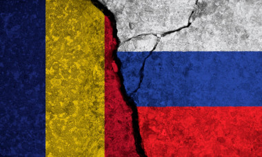 Political relationship between Romania and russia. National flags on cracked concrete background