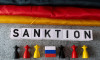 Bavaria, Germany - November 10, 2025: PHOTO MONTAGE, symbolic image of sanctions against Russia: The word SanctionÂť in f