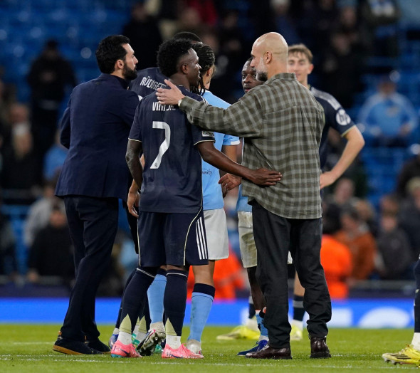 Manchester, UK. 17th Mar, 2026. Pep Guardiola coach of Manchester City (r) congratulates Vinicius Junior of Real Madrid (l) during the Manchester City vs Real Madrid UEFA Champions League round of 16 match at the Etihad Stadium, Manchester. Picture credit