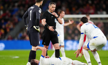 Referee Istvan Kovacs (centre) as Bosnia and Herzegovina's Ermedin Demirovic lays injured during the 2026 FIFA World Cup European Play-off Semi-final match at the Cardiff City Stadium. Picture date: Thursday March 26, 2026.