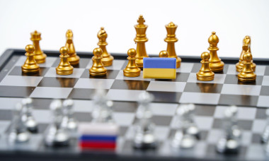 A chessboard with pieces and flags of Russia and Ukraine. Strategy, political game, and diplomacy.