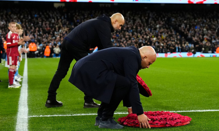 Liverpool manager Arne Slot (left) and Manchester City manager Pep Guardiola carrying poppy wreath for Remembrance Sunday ahead of the Premier League match at Etihad Stadium, Manchester. Picture date: Sunday November 9, 2025.