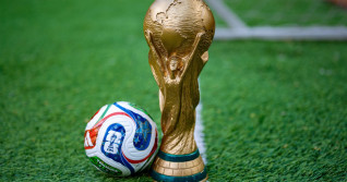May 7, 2026, United States. The trophy of the 2026 FIFA World Cup and the official Adidas Trionda ball on the green lawn of the stadium.