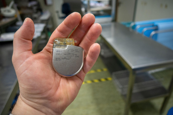 an explanted defibrilator is in one hand