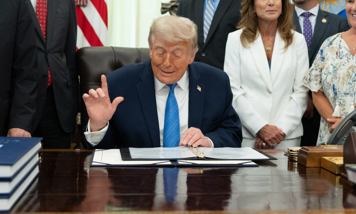 President Donald Trump signs the 
