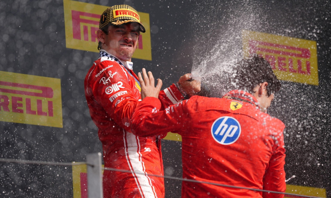 Ferrari driver Charles Leclerc celebrates on the podium with race engineer Bryan Bozzi after winning the British Grand Prix at Silverstone Circuit, Towcester. Picture date: Sunday July 5, 2026.