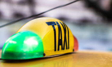 Taxi sign on yellow cab in the morning in Bucharest, Romania, 2020