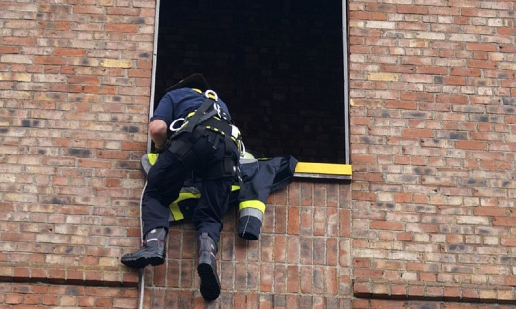 Feuerwehr, fire fighter rescuing victim from building