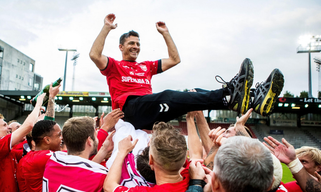 Vejle, Denmark. 14th July, 2020. Vejle Boldklub win promotion to the Danish 3F Superliga after a 1-0 win against Nykobing FC in the NordicBet Liga at Vejle Stadion in Vejle. Here the players pay tribute to manager Constantin Galca. (Photo Credit: Gonzales