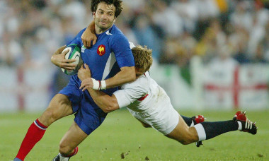 Christophe Dominici of France is tackled by Jonny Wilkinson