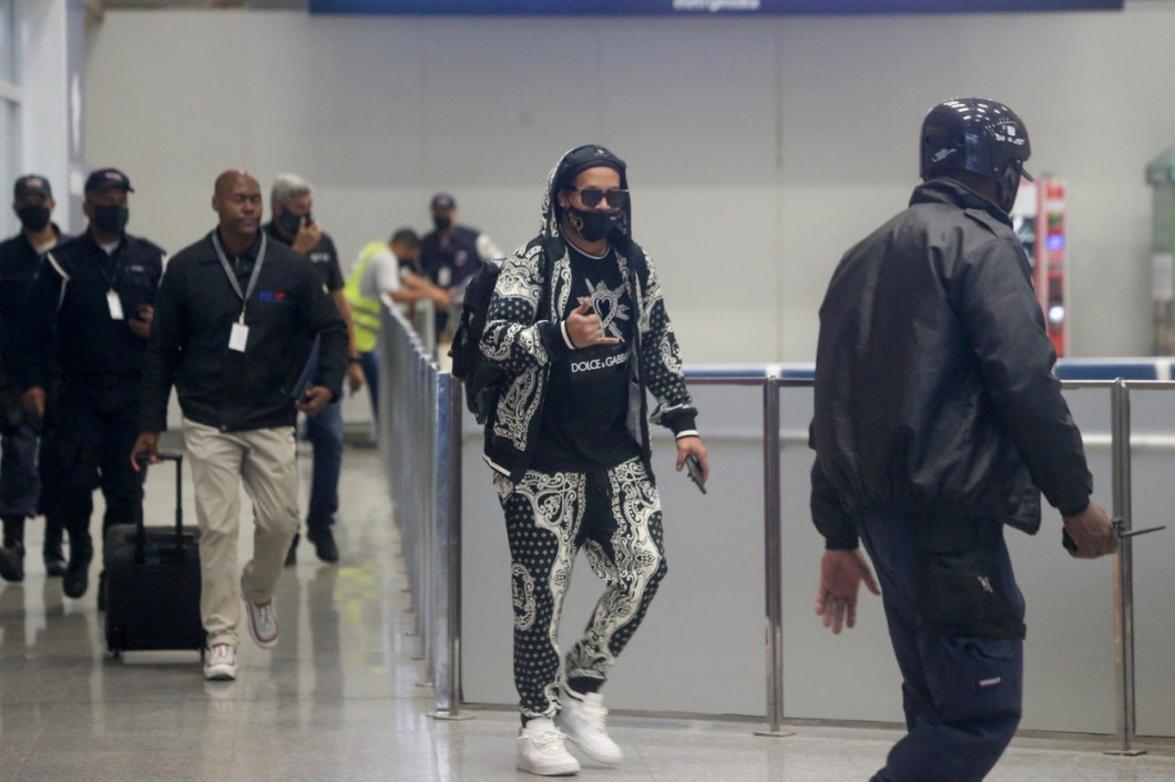 Ronaldinho Gaucho is greeted by fans and media as he arrives in Rio de Janeiro