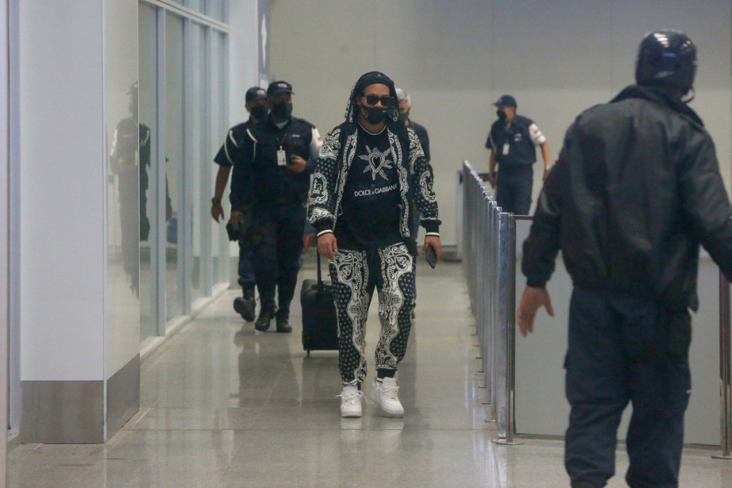 Ronaldinho Gaucho is greeted by fans and media as he arrives in Rio de Janeiro
