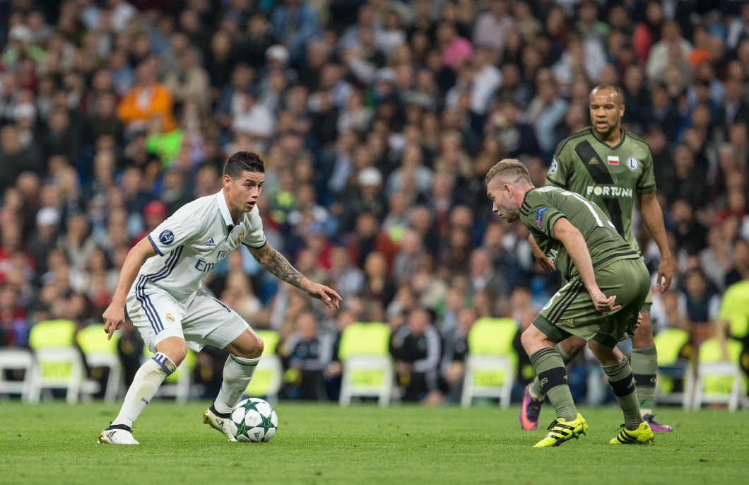 Madrid, Spain. 18th October, 2016. Real Madrid's Colombian midfielder James Rodriguez and Thibault Moulin of Legia Warszawa during the UEFA Champions League match between Real Madrid and Legia Warszawa at the Santiago Bernabeu Stadium in Madrid, Tuesday,