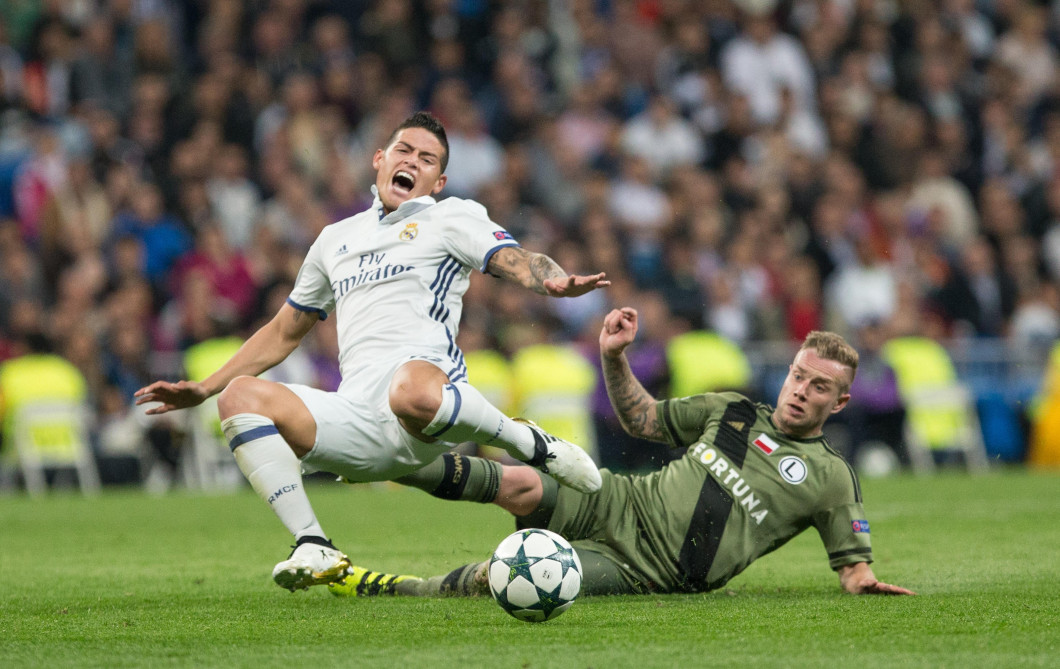 Madrid, Spain. 18th October, 2016. Real Madrid's Colombian midfielder James Rodriguez and Thibault Moulin of Legia Warszawa during the UEFA Champions League match between Real Madrid and Legia Warszawa at the Santiago Bernabeu Stadium in Madrid, Tuesday,