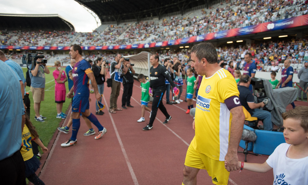 CLUJ, ROMANIA - JUNE 16, 2018: Football player Gheorghe Hagi (Romania Golden Team) and Barcelona Legends entering the playfield at the beginning of a