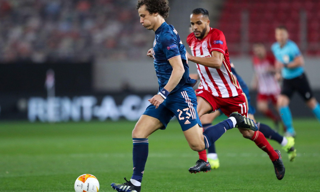 PIRAEUS, GREECE - MARCH 12: David Luiz of Arsenal FC and Youssef El Arabi of Olympiacos FC during the Olympiacos v Arsenal - UEFA Europa League Round